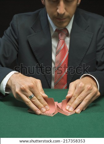 Man shuffling playing cards
