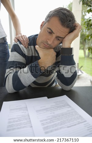 Man troubled reading over documents