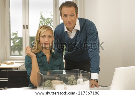 Portrait of two architects with an architectural model
