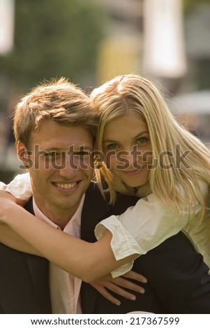 Portrait of a mid adult woman embracing a mid adult man smiling
