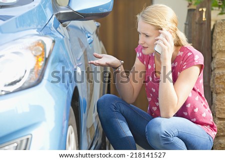 Woman Phoning Insurance Company To Report Car Damage