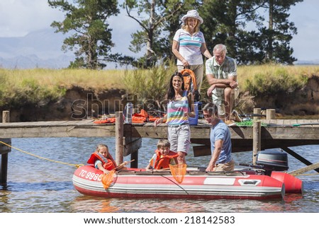 Multi-Generation Family Enjoying Boat Trip On Lake