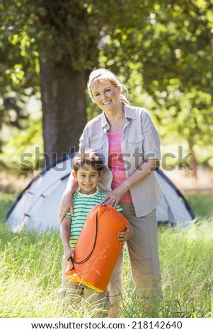 Grandmother And Grandson Enjoying Camping In Countryside