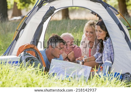 Adult Family Group Enjoying Camping Holiday In Countryside