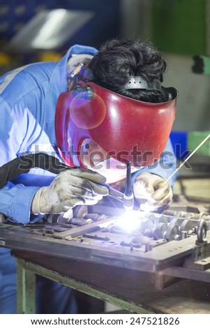 operator repair mold by TIG welding in manufacturing factory