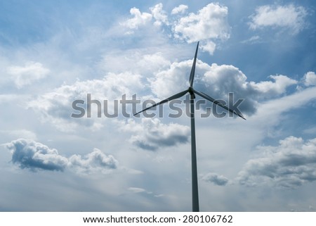 Green field of wheat and wind turbines generating electricity