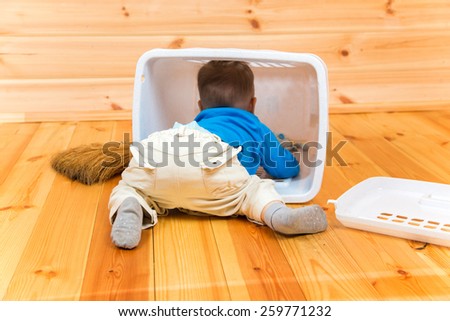Little active boy helps to clean the house getting inside bin