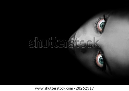 Portrait of the young and sexy woman with big eyes on the black background.