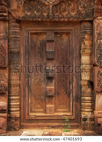 Beautifully carved stone door at the Banteay Srei temple (temple of women) near Angkor Wat (Siem Reap, Cambodia).