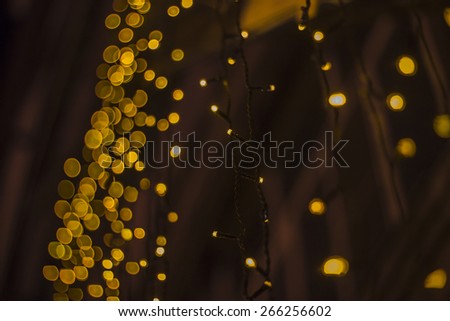 yellow string of lights at the black background