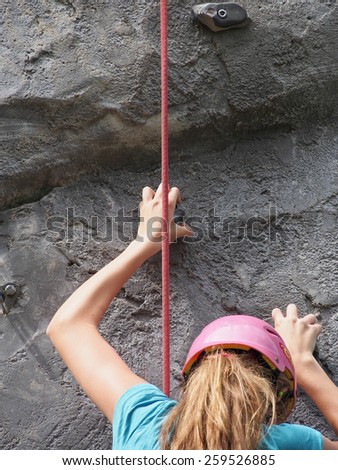unidentified girl climbing the wall