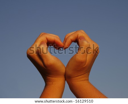 Heart shaped hands sunset