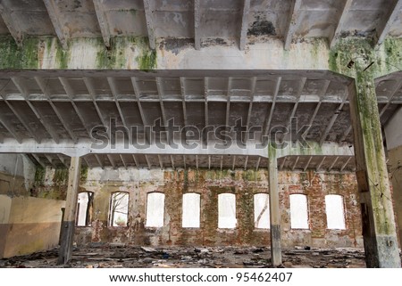 Discarded ruin with old windows and wall, industrial window in concrete wall