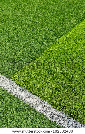 green synthetic grass sports field with white line