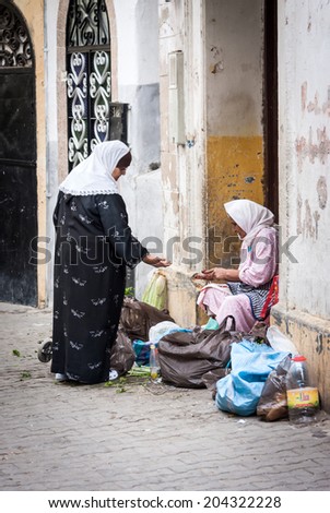 NOVEMBER 3.2013-TANGIER, MOROCCO: In the photo we see a woman selling her products and other shopping in the old medina of Tangier