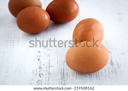 Red eggs on white wooden table