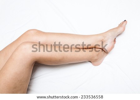 Shaved and smooth woman\'s long legs. Isolated on white