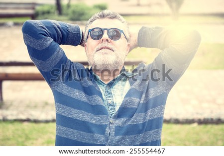 Attractive man 50 years old with beard and sanglasses