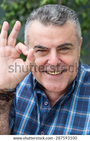 Brown attractive middle-aged man gesturing