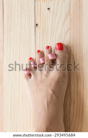 Woman painting toe nails / pedicure