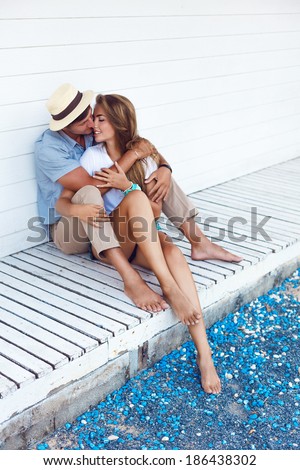 Happy couple in love posing outdoor in shabby chic interior and having fun. White background.