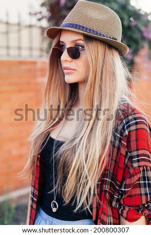 Fashion Hipster Woman Posing Outdoor. Plaid Shirt, Fashionable