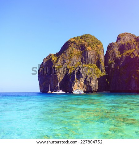 Outdoor image of amazing Koh Phi Phi, clear blue water, big mountains, beautiful exotic island in Thailand. Instagram bright colors.