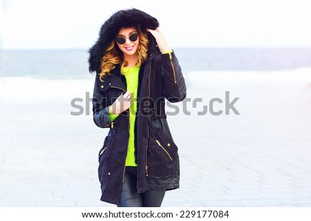 Portrait of young woman in warm clothes wearing winter parka