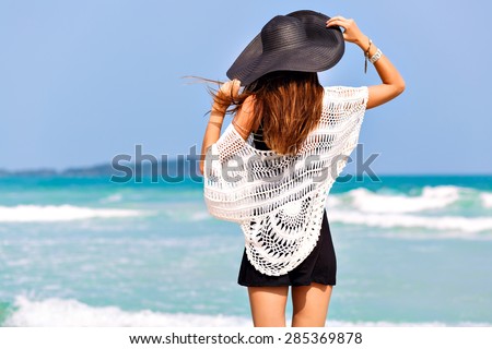 Fashion summer image of woman posing back, near blue sea water, nice sunny summer day , relax end enjoy freedom , joy, happiness, bright colors.
