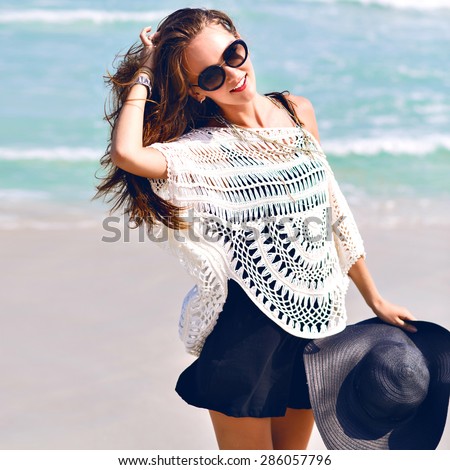 Close up summer fashion image of young stylish pretty woman enjoy her amazing vacation her ocean in tropical island, smiling and walking alone, vintage colors.