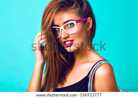 Close up fashion portrait of stunning sexy woman, hipster vintage sunglasses, bright make up, full lips, looking on camera, mint background. Student look.