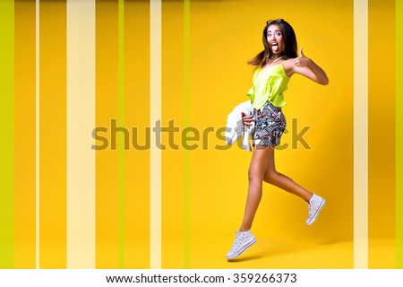 Bright trendy studio fashion image of sexy model, wearing neon bright color block clothes, casual vintage spring style, color pop, yellow background, hipster girl posing and having fun, fashionista.