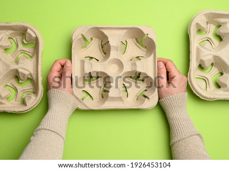 paper tray for drinks in takeaway cups on four cups  on a green background, top view