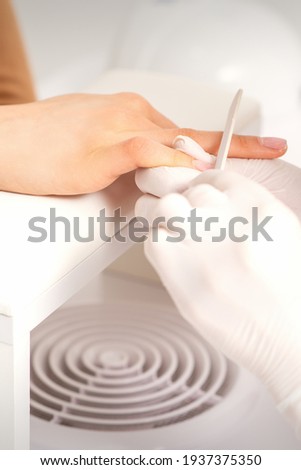 Hand receiving the nail file
