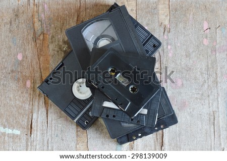cassette tape and video tape recorder on wood board
