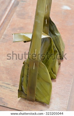 steamed flour with coconut filling on banana leaf packing