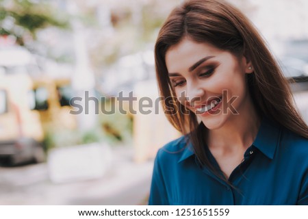 Concept of success and well-being. Close up portrait of smiling beautiful lady in stylish cloth being on street. Copy space on left