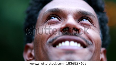 Portrait close-up face man looking at the sky feeling hope and faith