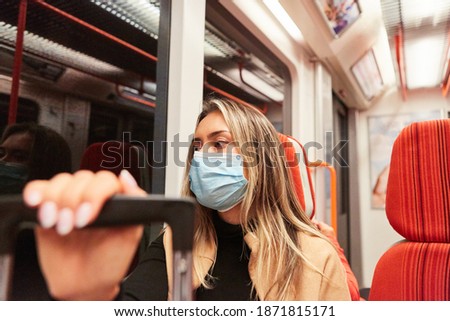 Commuter on bus and train in local transport with face mask because of Covid-19 pandemic