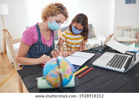Child home studying education, homeschooling, with private tutor mother in the time of viruses, flu and seasonal pandemic.