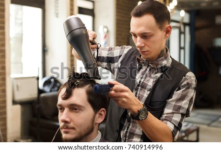 Barber make haircut with hair dryer in barbershop. Hairstyle in male hair salon