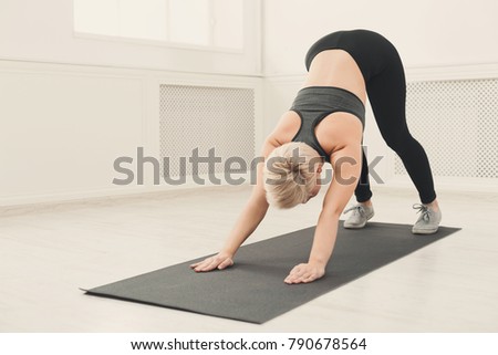 Yoga stretching. Woman in dog pose. Young slim girl makes exercise. Healthy lifestyle, fitness concept