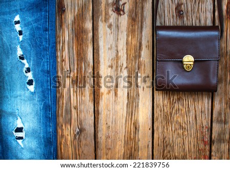 Old style fashion background with jeans and vintage bag. Place for text