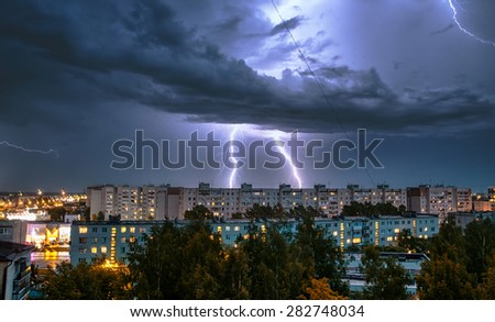 night thunderstorm over the buildings in the city