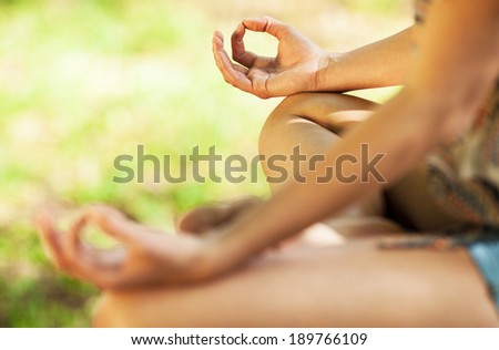 Young attractive woman meditate in nature.