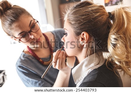 Make-up artist work on her friend.Real people.