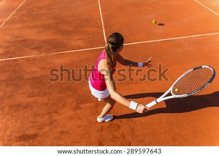 Young woman playing tennis.High angle view.Forehand .