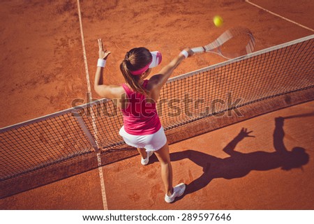 Young woman playing tennis.High angle view.Forehand volley.