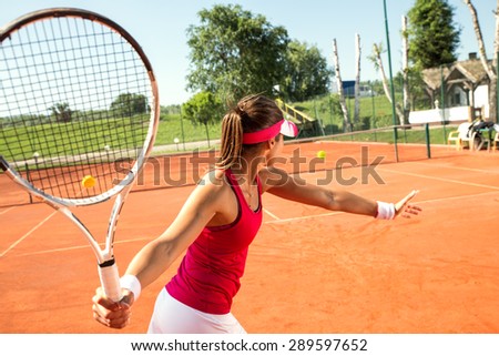 Young woman playing tennis.Forehand .
