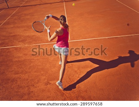 Young woman playing tennis.High angle view.Forehand.